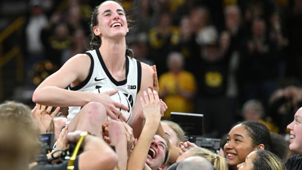 Feb 15, 2024; Iowa City, Iowa, USA; Iowa Hawkeyes guard Caitlin Clark (22) reacts with teammates after the game. Clark broke the NCAA women's all-time scoring record against the Michigan Wolverines at Carver-Hawkeye Arena.